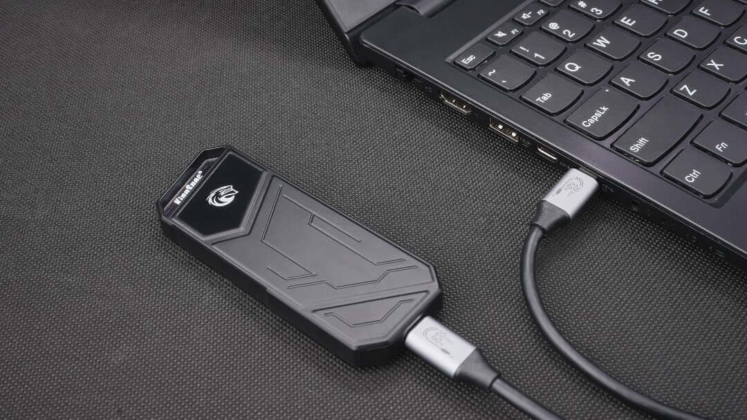 UTZYx Super Fast SSD KingSpec 2TB connected to a laptop via USB, showcasing its sleek design and portability.